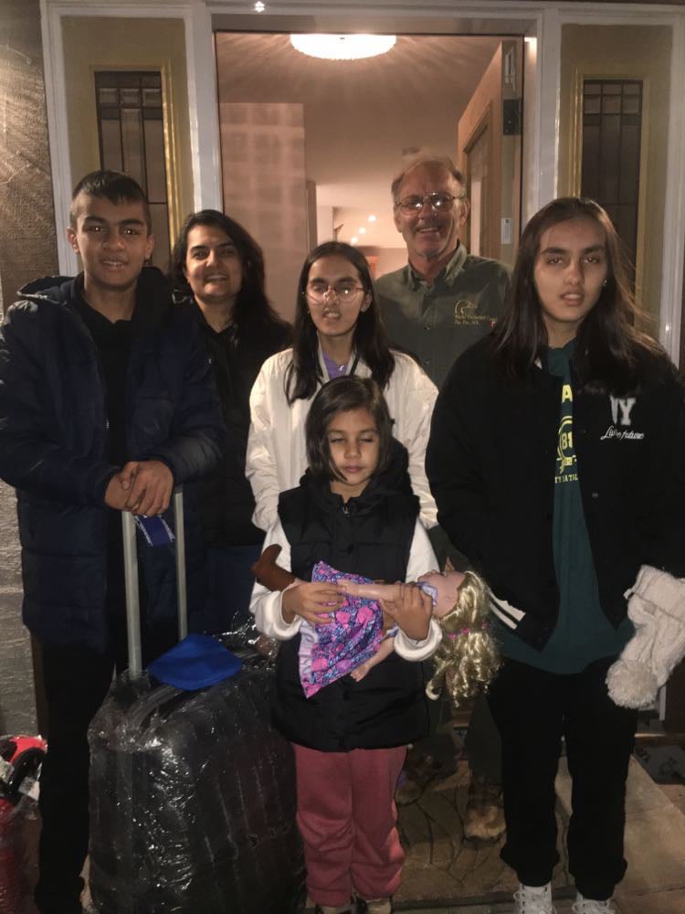 Nick with refugee family